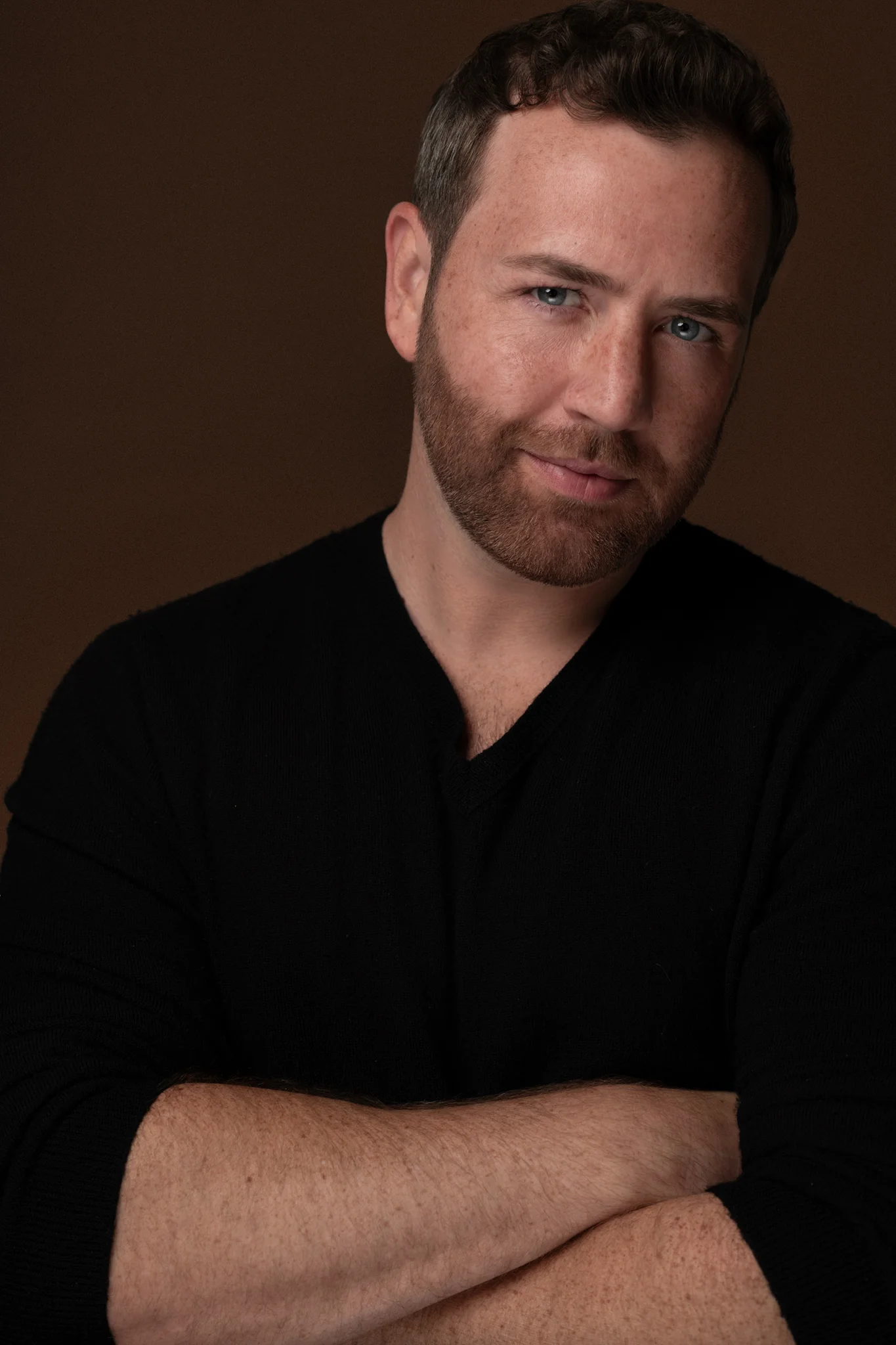 Kevin Pettei — arms crossed, warm tones